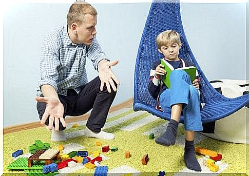 Father points out to his son all the scattered toys