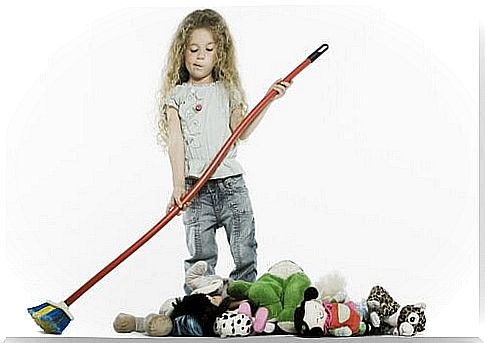 Little girl arranges her toys