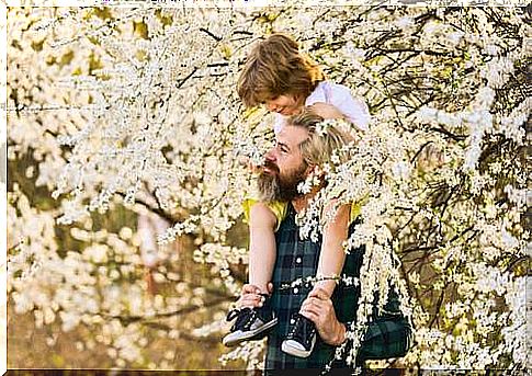 Father and son strolling among the flowering trees.