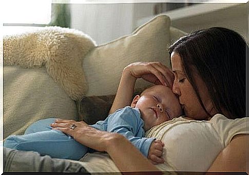 Mom with baby in her arms on the sofa