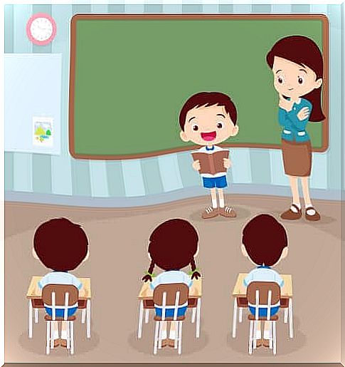 Child reading in front of his classmates and the teacher.