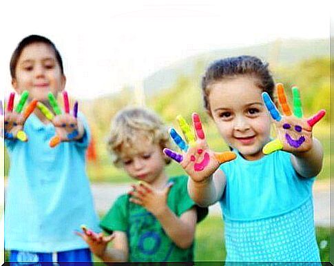 children with colorful hands and fingers