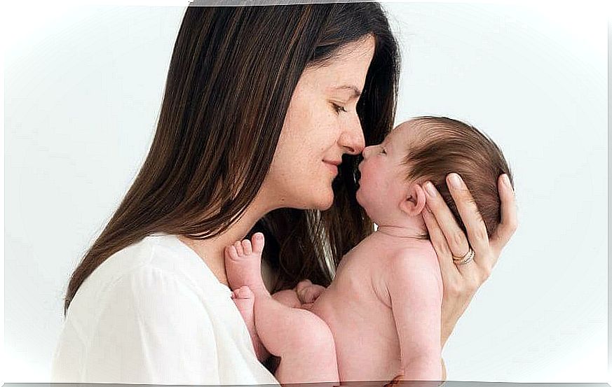 mom holds newborn baby in her arms