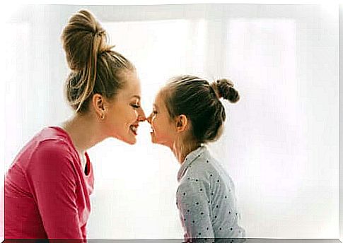 Mom and daughter kiss Eskimo