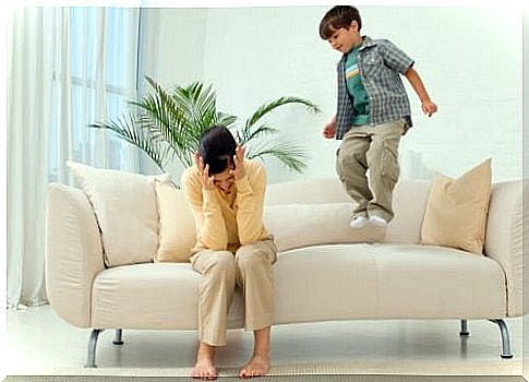 Disobedient child jumps on the sofa