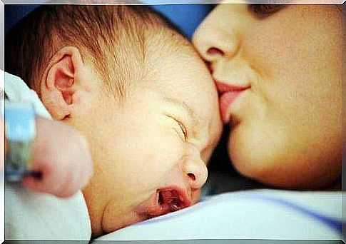 Mom kissing son on the head 