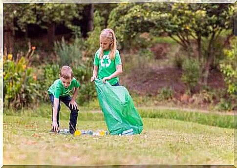 children picking up plastic in a park