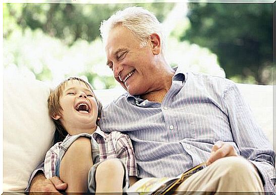 grandfather and baby sitting on the sofa