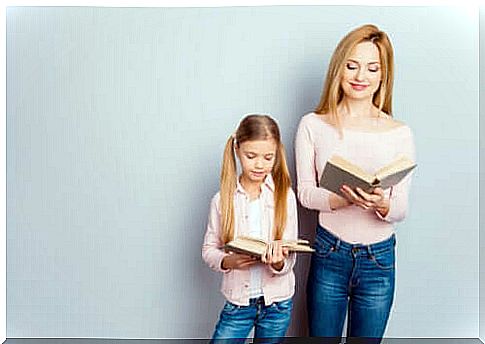 Mother and daughter read a book