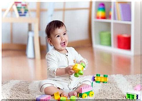 Motor Skill Games.  Baby with toys on the carpet.