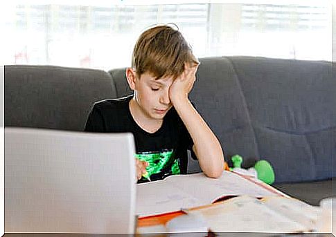 Teenage boy in front of computer having difficulty with homework.