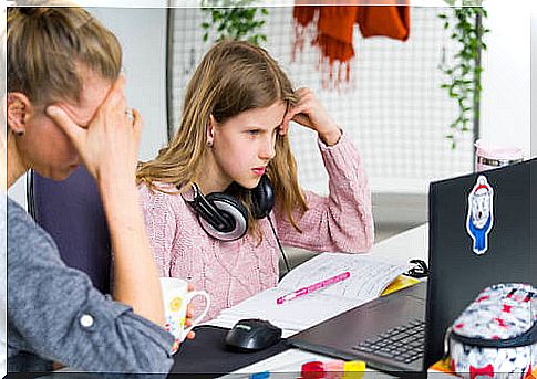 Mother helping her teenage daughter to study because the girl has learning difficulties.