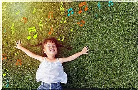 Little girl listening to music on the lawn