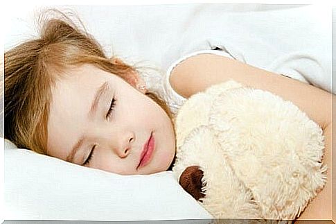 Baby girl sleeps with soft toy