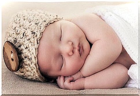 Baby with hat sleeps