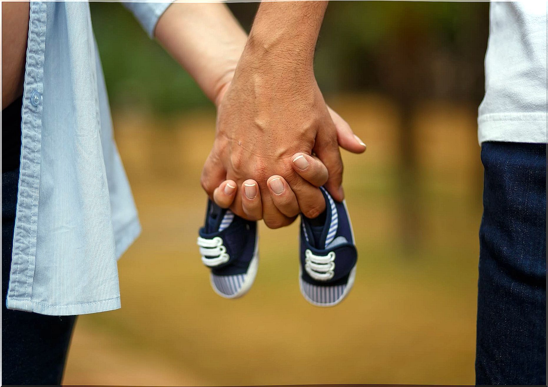 United hands holding some shoes