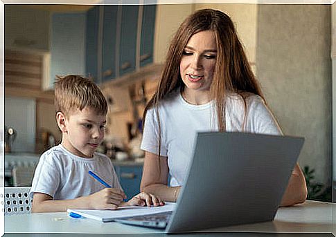 Mother helping son with homework.