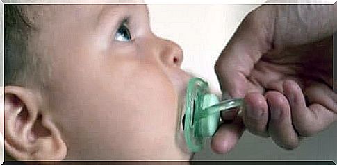 Remove the pacifier from the baby.