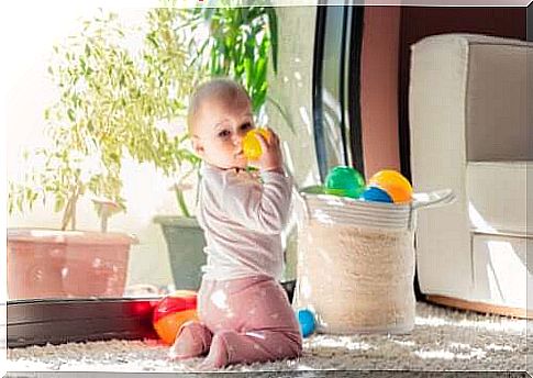 Stages of child development.  Child playing with balls contained in a basket.