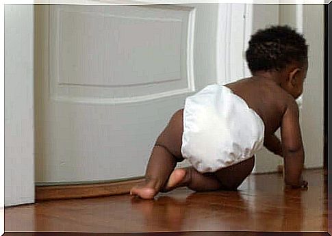 Stages of child development. Baby in diaper crawling.