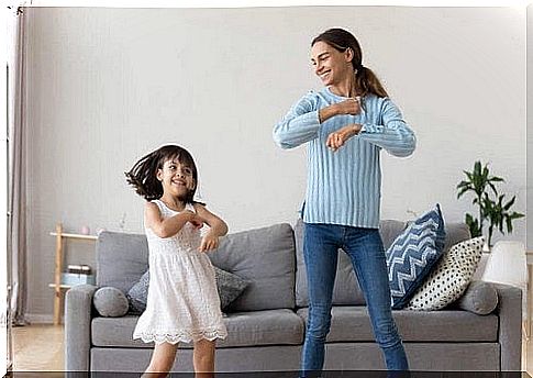 Mom and daughter dancing.