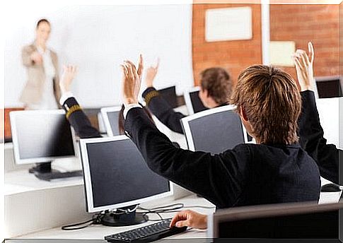 pupils in class raise their arms