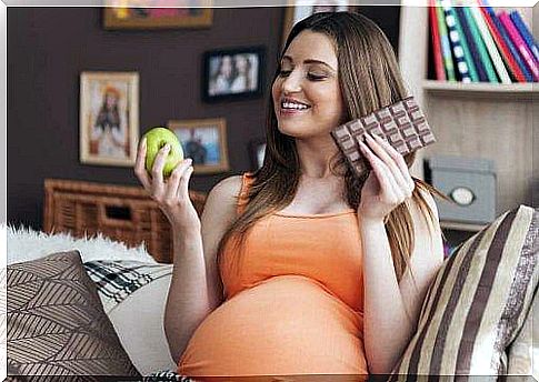 pregnant woman with apple and chocolate 