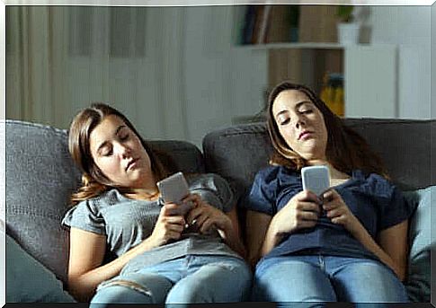 Bored teenagers looking at their cell phones without doing their homework.