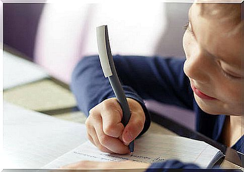 Child writing sentences in a notebook to improve spelling.